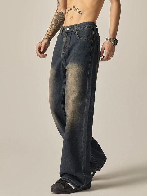 Loose blue denim pants stacked over black shoes