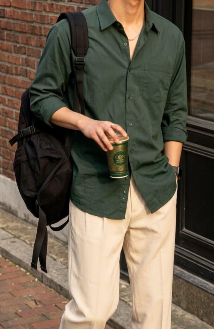Green casual button-up shirt styled with cream trousers