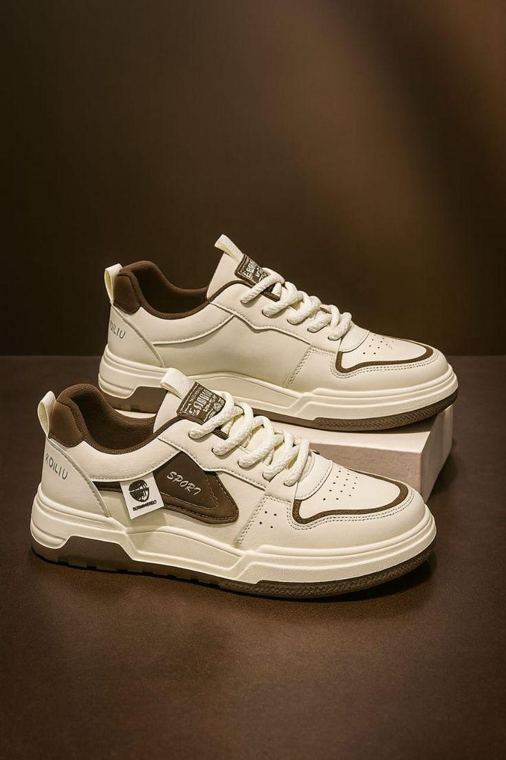 White and cream sneakers on a warm brown display